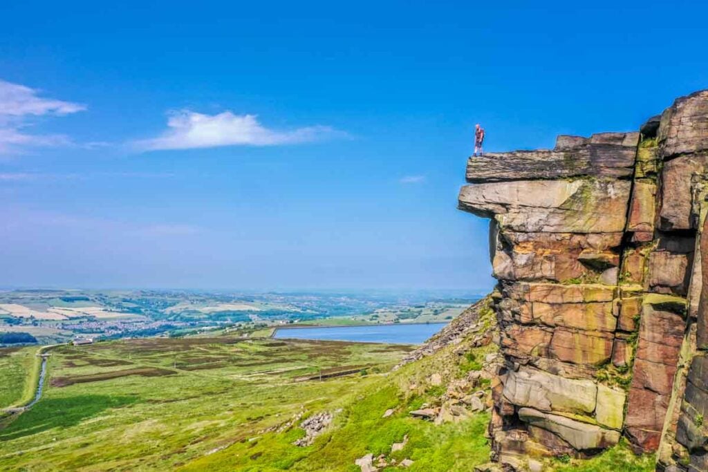 paul steele on cliff top with blue sky background