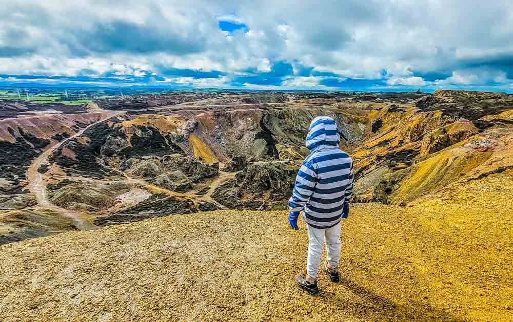 child looking at the view from top of the hill