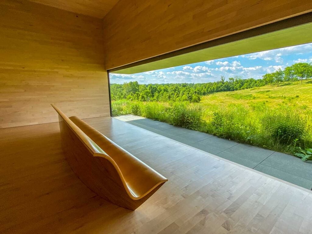 Room 7 of The Pavilions at Glenstone, feature a large, landscape picture window and curved bench