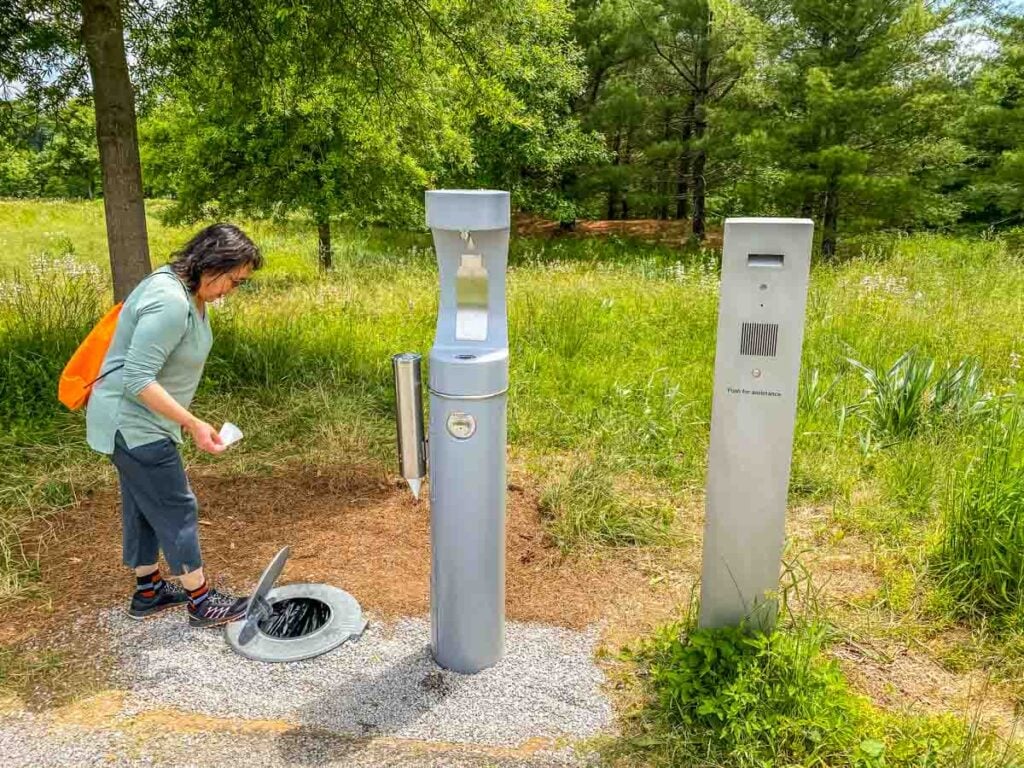 A minimalist, metal rubbish receptacle, water station and call box, all of which blend into the landscape without marring it