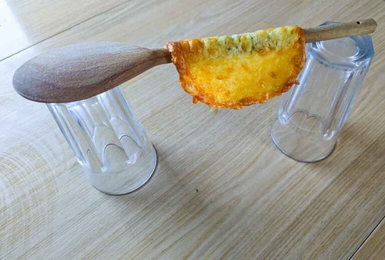 shaping the cheesy taco shells over a spoon