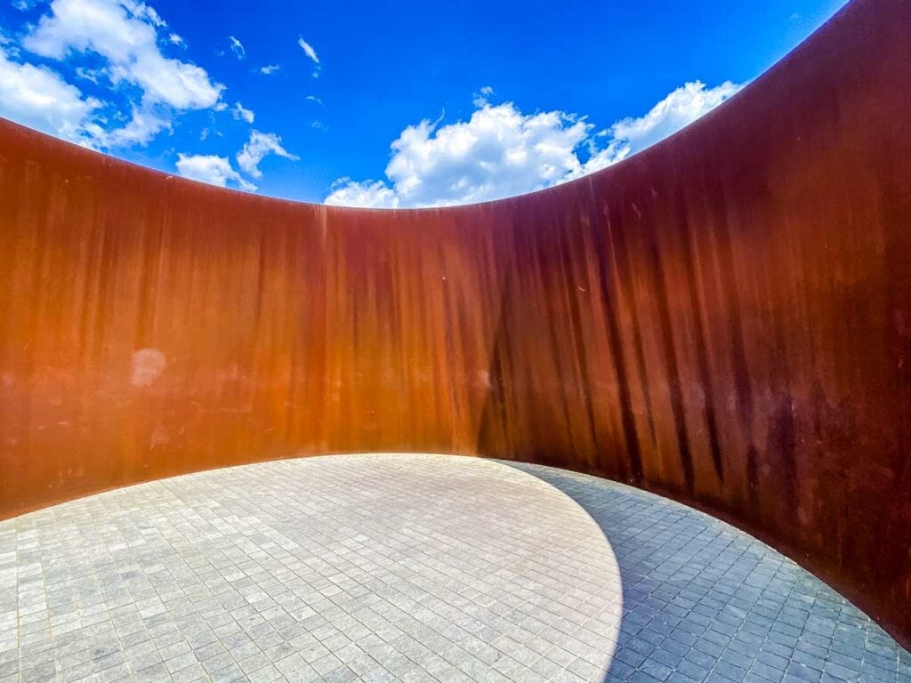 The sun casts a shadow on the ground at the center of Richard Serra's sculpture Sylvester